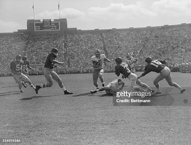 Paul Horning of Notre Dame splits through the line for the first touchdown of the 1955 Notre Dame Football season in 1st quarter play. The Irish won...