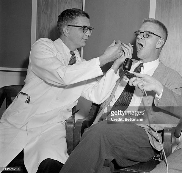 Dr. Harry L. Williams administers LSD 25 to Dr. Carl Pfeiffer, chairman of Emory University's Pharmacological Department, to produce effects similar...