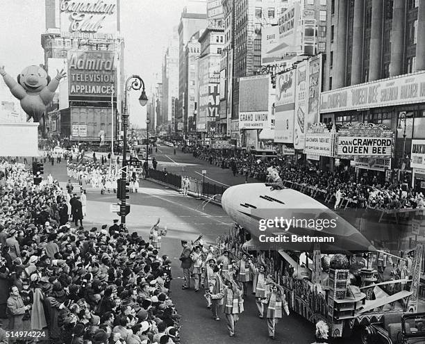 Macy's 1955 Thanksgiving Day Parade passes Times Square in New York City.