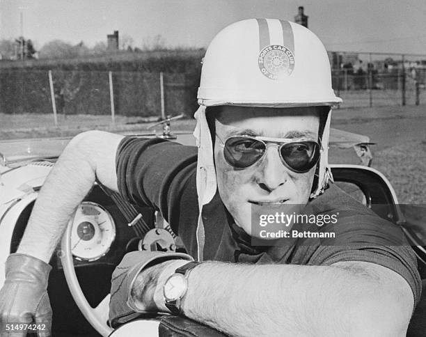 John Weitz, noted both as a sportscar racer and fashion designer, relaxes after a practice spin in the Morgan racer he will drive in the Sebring...