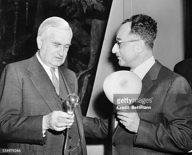 Michel Macksoud , inventor of the revolutionary new light source, "fluomeric," shows his new development to Charles A. Edison, former New Jersey...