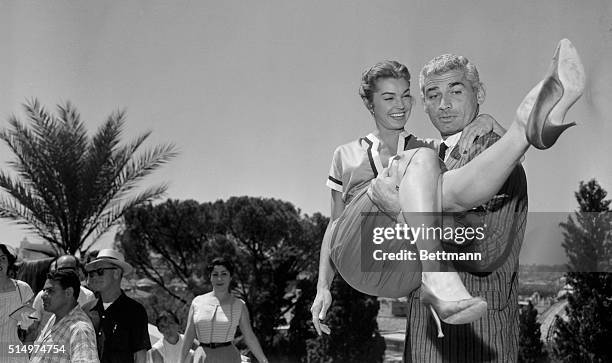 Star is born as actress Esther Williams gets a lift from the strong arms actor Jeff Chandler at the Pincio Terrace in the famed Borghese Gardens of...