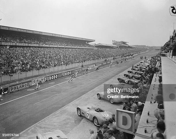 Race car drivers run across the track at Le Mans, signalling the start of the 1956 Le Mans Grand Prix endurance race. A Scottish team of Ron...