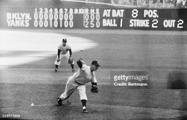 New York Yankee's pitcher Don Larsen delivers a third-strike pitch to dodger pinch-hitter Dale Mitchell for the final out in the first perfect game...