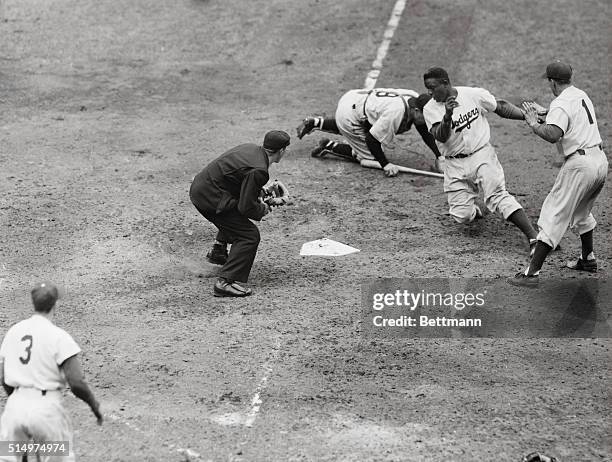 With catcher Mueller of the Pittsburgh Pirates, making the out, Jackie Robinson of the Brooklyn Dodgers is shown out at home plate on teammate Gil...