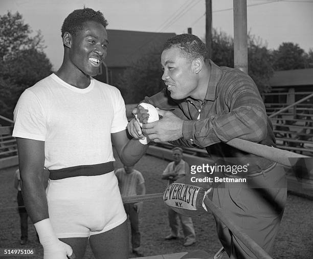 "The Champ" Visits His Heir. Pompton Lakes, New Jersey: Joe Louis, who retired as undefeated heavyweight ring champion of the world calls on the man...