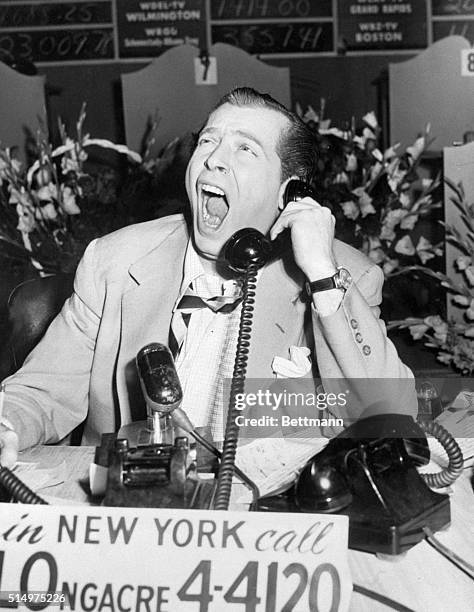 New York, NY- Comeidian Milton Berle yawns as he takes the last call this morning on his 21-and-a-half-hour "Telethon" over television to raise money...