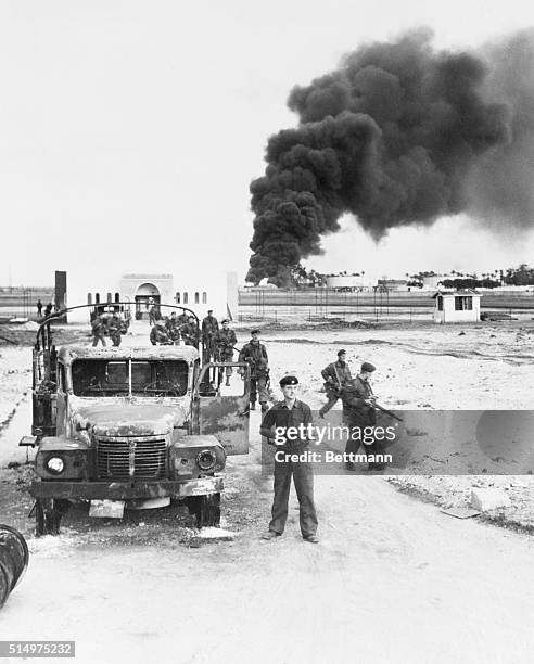 British at Port Said. Port Said, Egypt: British troops advance through Port Said as oil installations burn during the Anglo-French invasion of the...