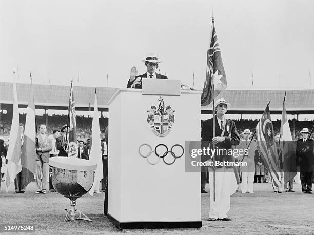 Australian middle distance runner John Landy takes the Olympic oath on behalf of the assembled athletes during the Olympic Games opening ceremony...