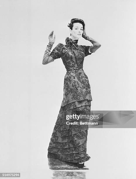 Column of grace and beauty, artfully tiered from mid-thigh to hem, this dinner gown by Gres borrows cover-up elegance from the era of "My Fair Lady"....