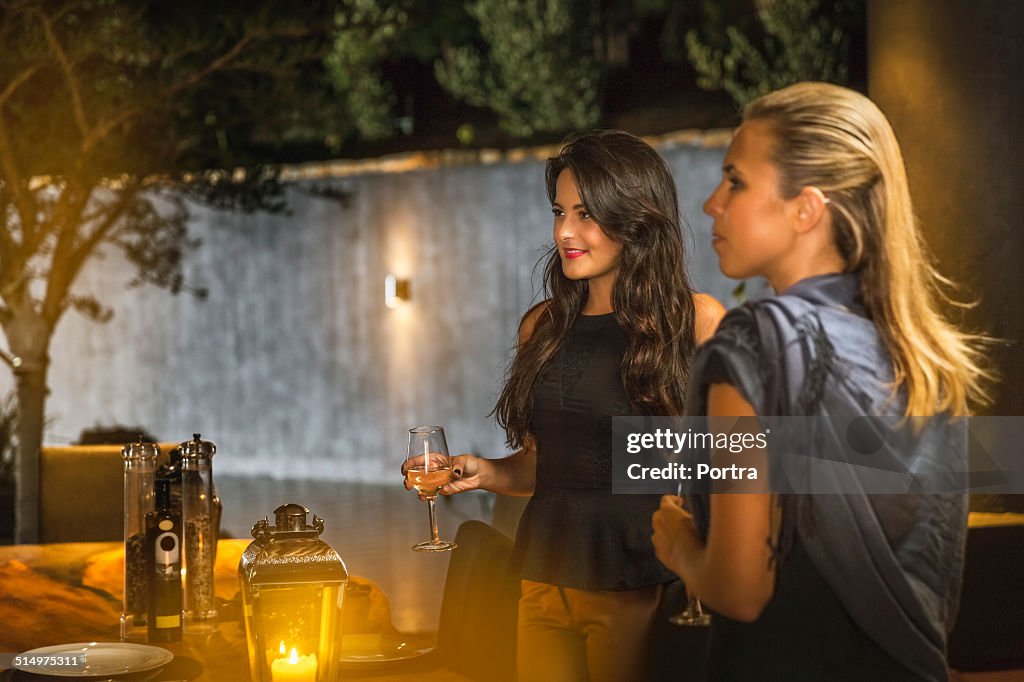 Women holding wineglasses at party