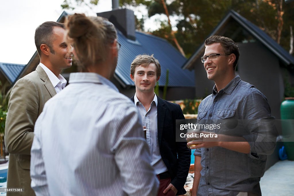 Male friends communicating while having beer