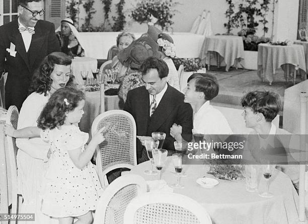 Rita Hayworth and her new husband are shown as they caught their breaths during a lull in the festivities that followed their wedding Friday. Prince...