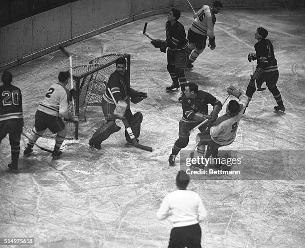 Rangers' Frank Eddolls , blocks Montreal Canadiens' Maurice Richard during the second period of tonight's opener of the first-round Stanley Cup...