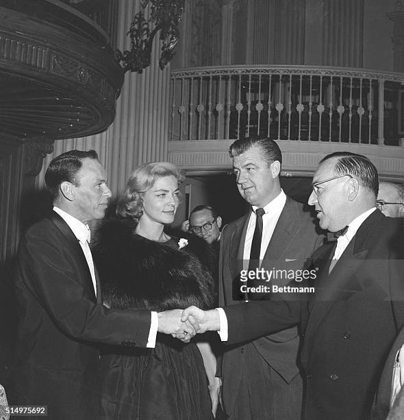 Frankie Was There. Los Angeles, California: Singer Frank Sinatra, escorting Lauren Bacall , shakes hands with California attorney general, Edmund G....