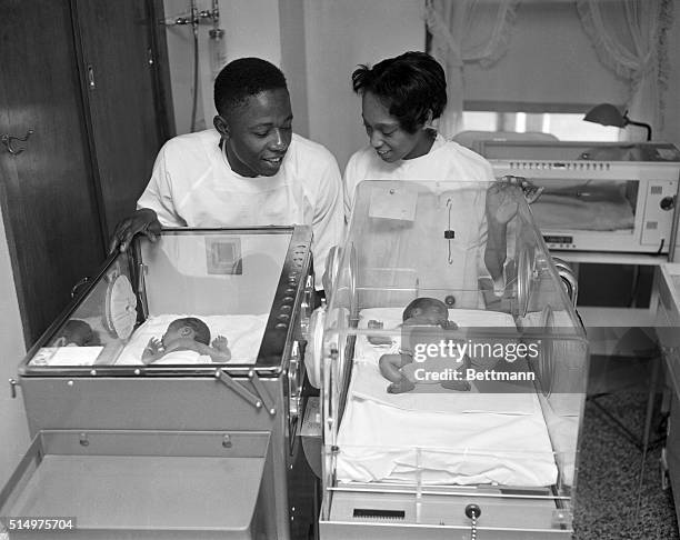 Hank Aaron, Milwaukee Braves outfielder and his wife Barbara look at twin boys born 12/15 at St. Anthony Hospital. Larry weighed 3 lbs 6oz and Gary,...