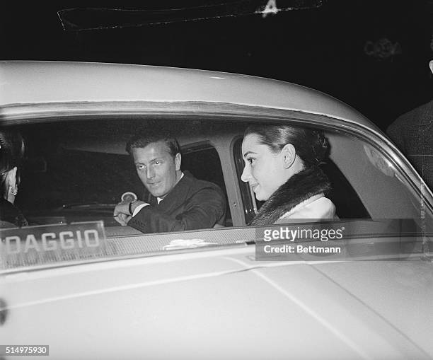 In the company of a friend of hers, French fashion designer Hubert de Givenchy, Hollywood actress Audrey Hepburn is seen through the window of a car...