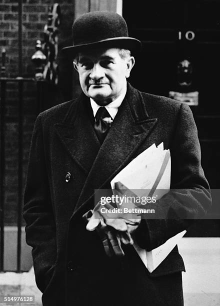 Photo shows Field Marshal Sir William Slim in civilian clothing, arriving at 10 Downing Street today to attend an emergency meeting of the cabinet.