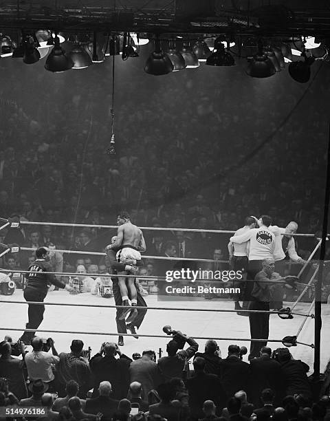 March 25, 1958 - Chicago, Illinois: Victorious Sugar Ray Robinson is lifted by his manager, Harold "Killer" Johnson, after Robinson defeated Carmen...