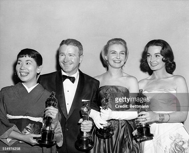 Oscar winners pose from left to right: Miyoshi Umeki and Red Buttons, voted Best Supporting Actress and Actor for their roles in Sayonara, Joanne...