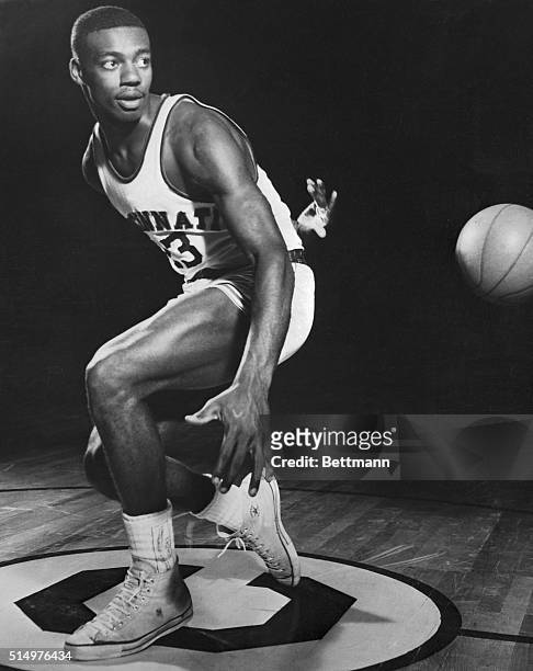Oscar Robertson, college basketball player, is shown throwing the ball behind his back.