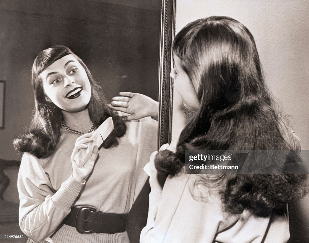 Opera singer Roberta Peters Combing Hair in Mirror