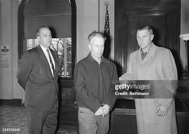 Farmer Ed Gein , confessed slayer of two women, stands with his Arthur Schley in the Wabsara county Court here November 21st. Gein was charged with...