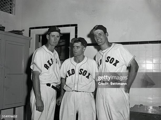 At left is Ted Williams, Boston Red Sox slugger as he stands in front of the scoreboard in the first half of the ninth inning of the game against St....