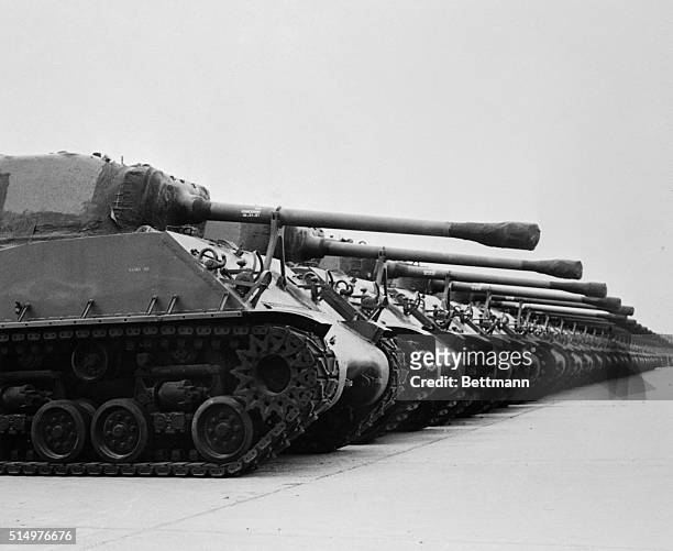 Tanks stand in long even rows alongside other ordnance equipment at Red River Arsenal near Texarkana, Texas. These tanks were reconditioned since...