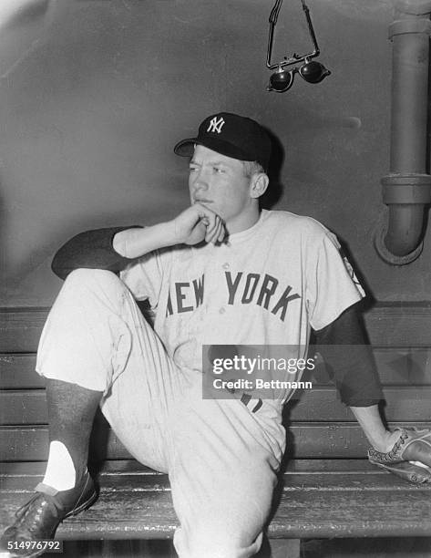 Nineteen year old Mickey Mantle, rookie outfielder for the New York Yankees is pictured here sitting on bench prior to playing left field in today's...