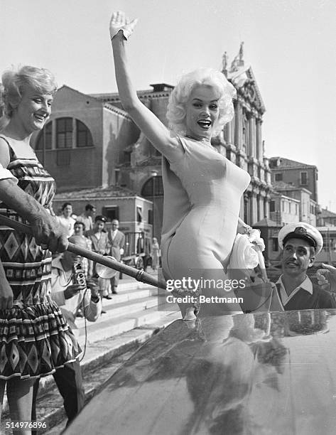 Sight to make a Venetian blind, Hollywood's Mamie Van Doren waves hello to the city of canals from a motorboat. She arrived in Venice for the 19th...