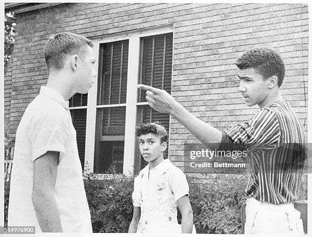 Anger in Little Rock. Little Rock, Ark.: Johnny Gray points a warning finger at one of the two white boys who tried to force him and his sister Mary...