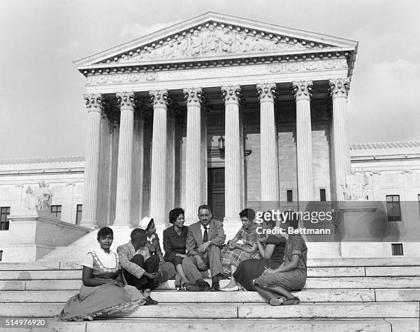 Six black children who attended Little Rock's Central High School earlier in 1958, and two NAACP officials sit outside the Supreme Court in this...