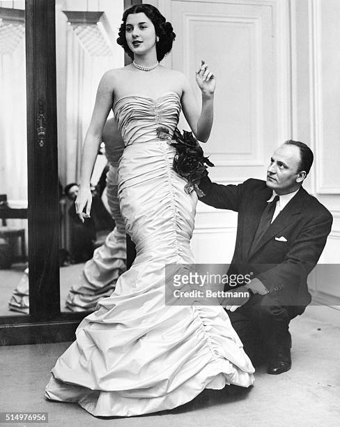 March 14, 1951-Paris, France: Janine Holland, a 21-year-old 'Maid of Cotton, 1951' of Houston, Texas, is shown in a cotton evening gown designed...