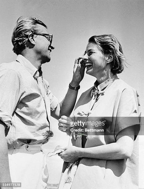 Although something seems to have gotten into her eye, actress Ingrid Bergman appears unconcerned as husband-to-be Lars Schmidt tries to spot the...
