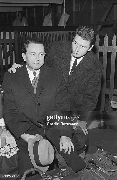 Dr. Ferdinand Porsche and his son Ferdinand, Jr., sit atop their luggage aboard the liner "America" here Nov. 10th after their arrival from Europe....
