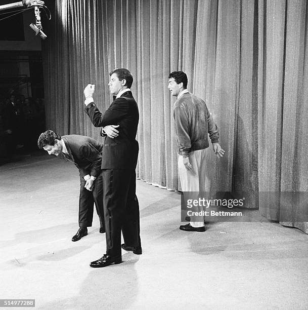 Hollywood: In the middle of a comedy sketch on the Eddie Fisher show, singer Dean Martin, , breaks through the curtains yelling "Don't sing, don't...