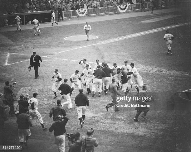 Members of the New York Yankee Team from a happy group on the field at Yankee Stadium today after Bauer caught Giant Yvars' fly to right field to end...