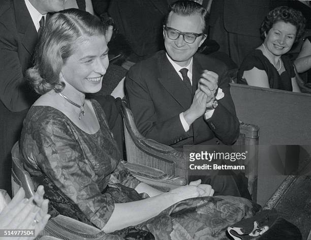 Applause for Ingrid. Paris: As actress Ingrid Bergman smiles in acknowledgement, husband Lars Schmidt leads the applause as they attend the premiere...