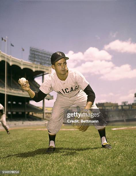 Chicago White Sox infielder Luis Aparicio, is captured just as he is about to throw the baseball on the ground for fielding practice.