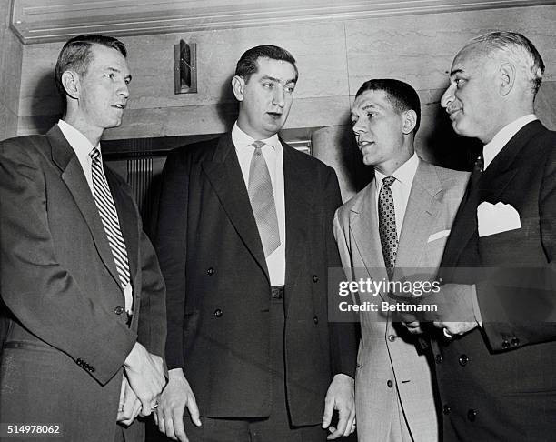 Seven-foot Bill Spivey, former University of Kentucky basketball star, is shown with his attorneys, John Young Brown and Elmer Drake, as he appeared...