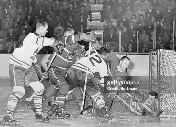 As Toronto's Ron Stewart tries desperately to push the puck into the cage, Montreal defensemen bar the way during the game in the Stanley Cup...