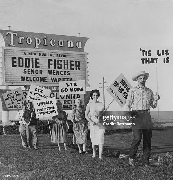 Protest Fisher-Taylor romance...A sign-carrying group demonstrates in front of the Tropicana Hotel here April 2nd, where Eddie Fisher opened an...