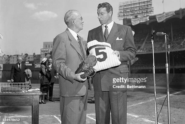 Joe DiMaggio, who retired from baseball after a great career last season's end, is shown as he turned over his famed No.5 uniform and glove to Rolan...
