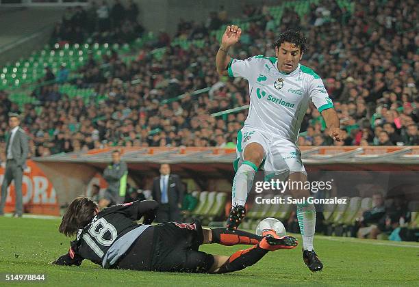 Jose Martinez of Pachuca slides for the ball as Martin Bravo of Santos Laguna tries to dribble during the 10th round match between Santos Laguna and...