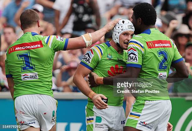 Jarrod Croker of the Raiders celebrates with team mates after scoring a try during the round two NRL match between the Canberra Raiders and the...