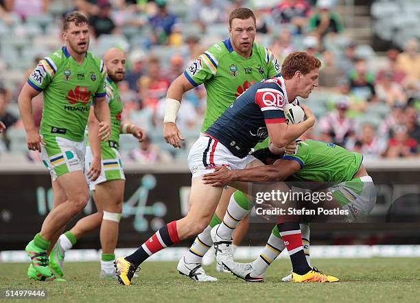 Dylan Napa of the Roosters is tackled during the round two NRL match between the Canberra Raiders and the Sydney Roosters at GIO Stadium on March 12,...