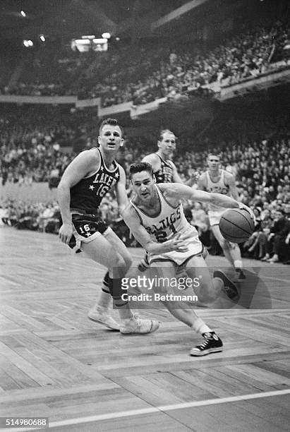 Bill Sharman of the Boston Celtics puts on a burst of speed and catches Dick Garmaker of the Minneapolis Lakers flat footed as he drives in for a...