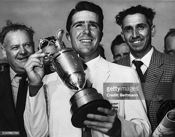Holding up his trophy, Gary Player , winner of the British Open Golf Championship, smiles here, July 3rd. Player comes from South Africa. His winning...