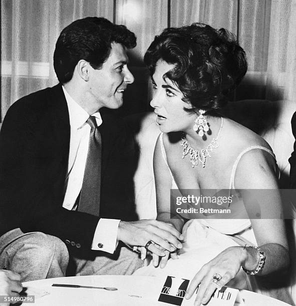 Las Vegas, NV- Actress Elizabeth Taylor, wearing the 50-diamond bracelet given to her by Eddie Fisher, holds hands with the singer after his opening...